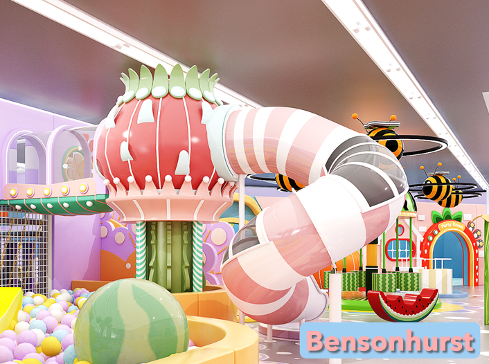 Child sliding down a colorful dragon fruit-themed indoor slide at Rainbow Playspace