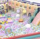 Kids playing in a gigantic colorful ball pit with obstacle course and ball blaster